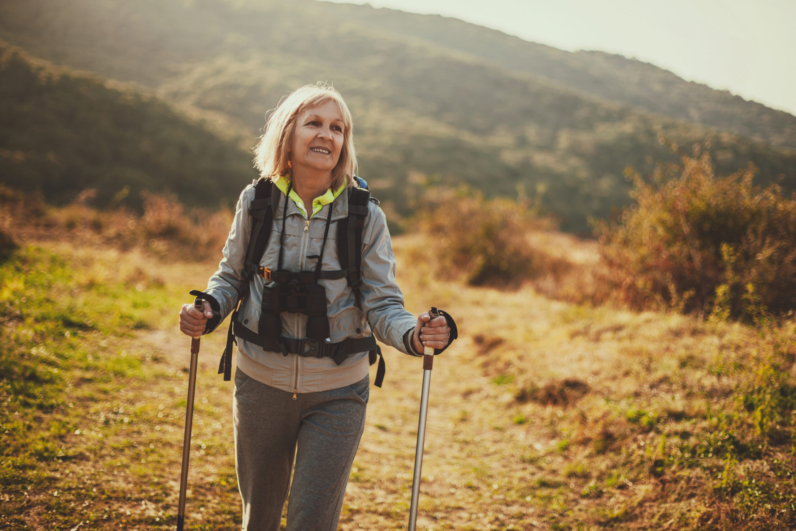 Senior woman is hiking in mountain. Active retirement.